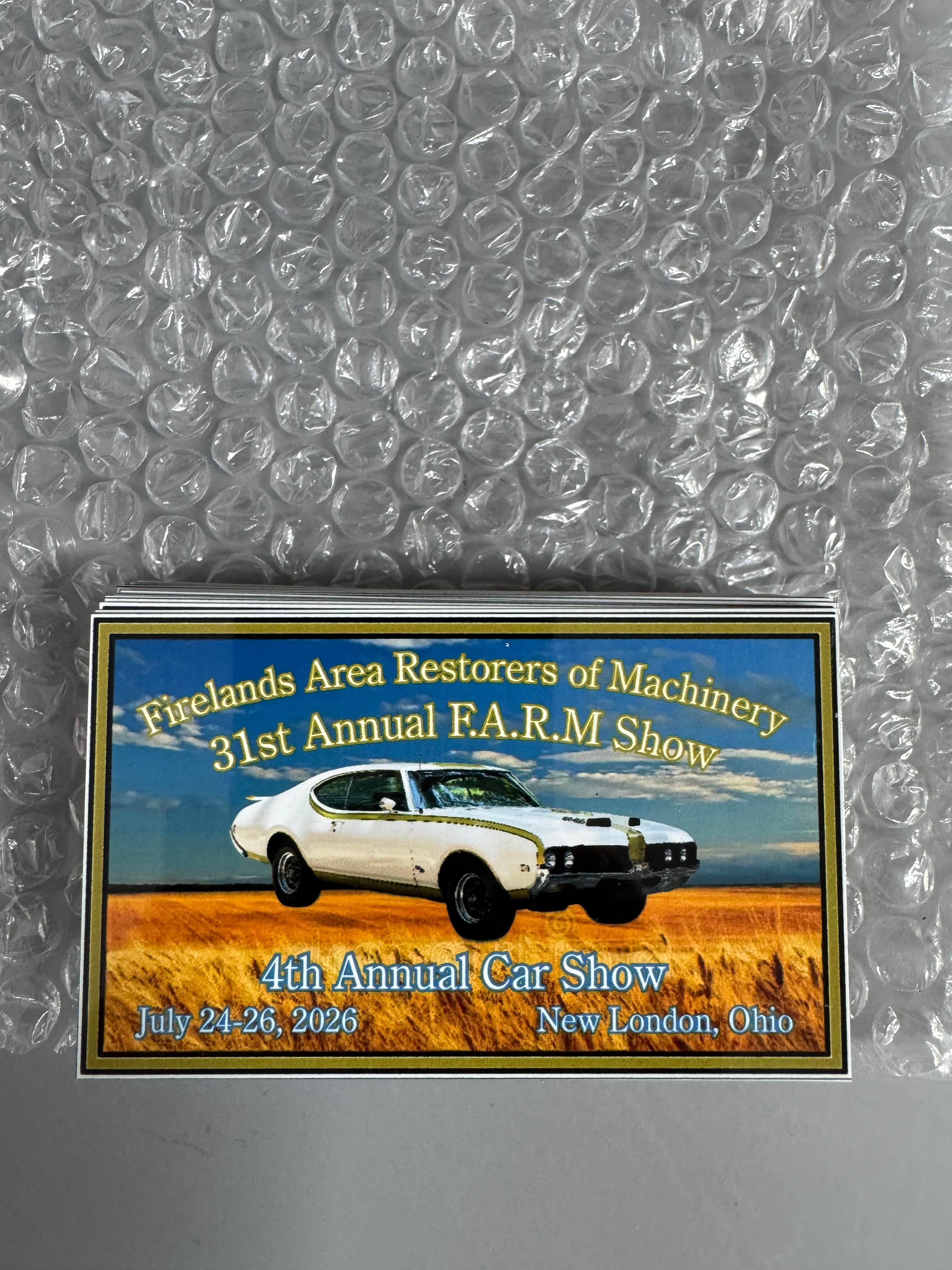 Flyer for the 31st Annual F.A.R.M Show featuring a white muscle car in a field.